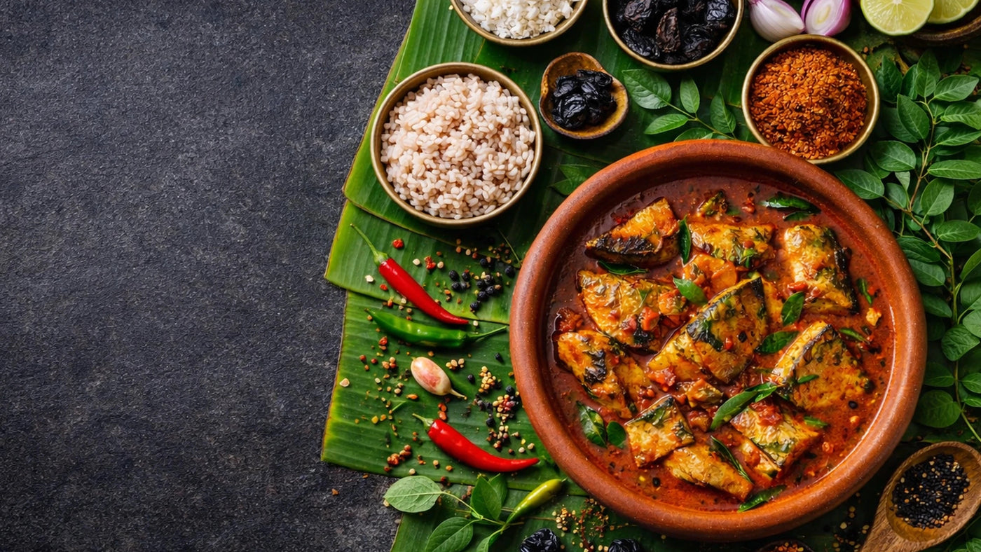 Bowl of fish curry with side dishes on a leafy background